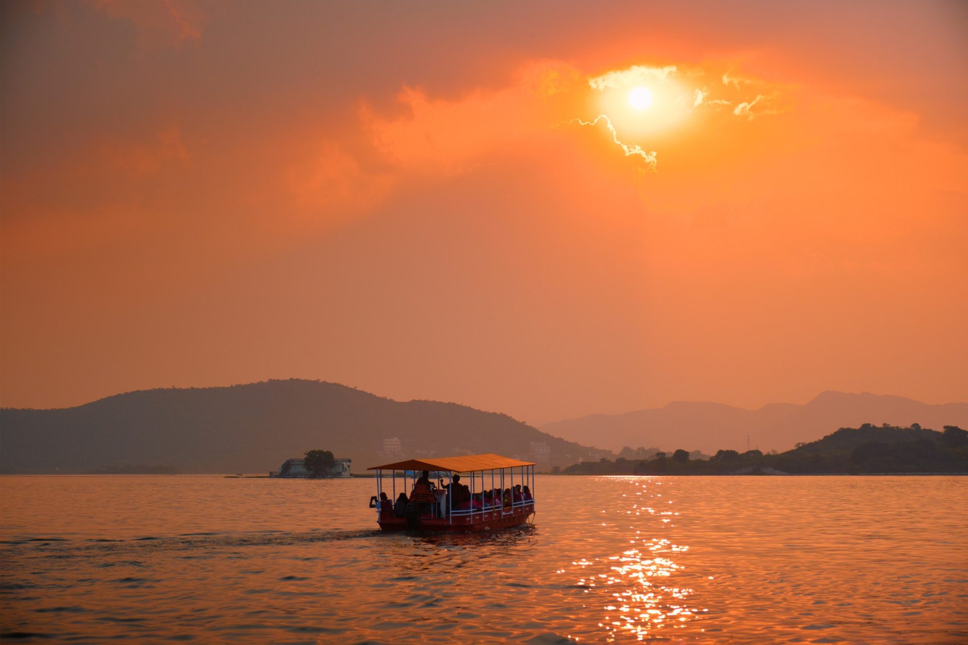 Boat in lake Pichola on sunset. Udaipur, Rajasthan, India
